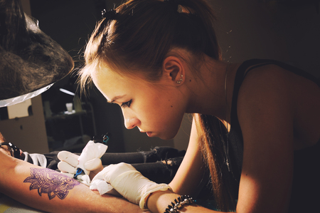 tattoo artist performing tattoo